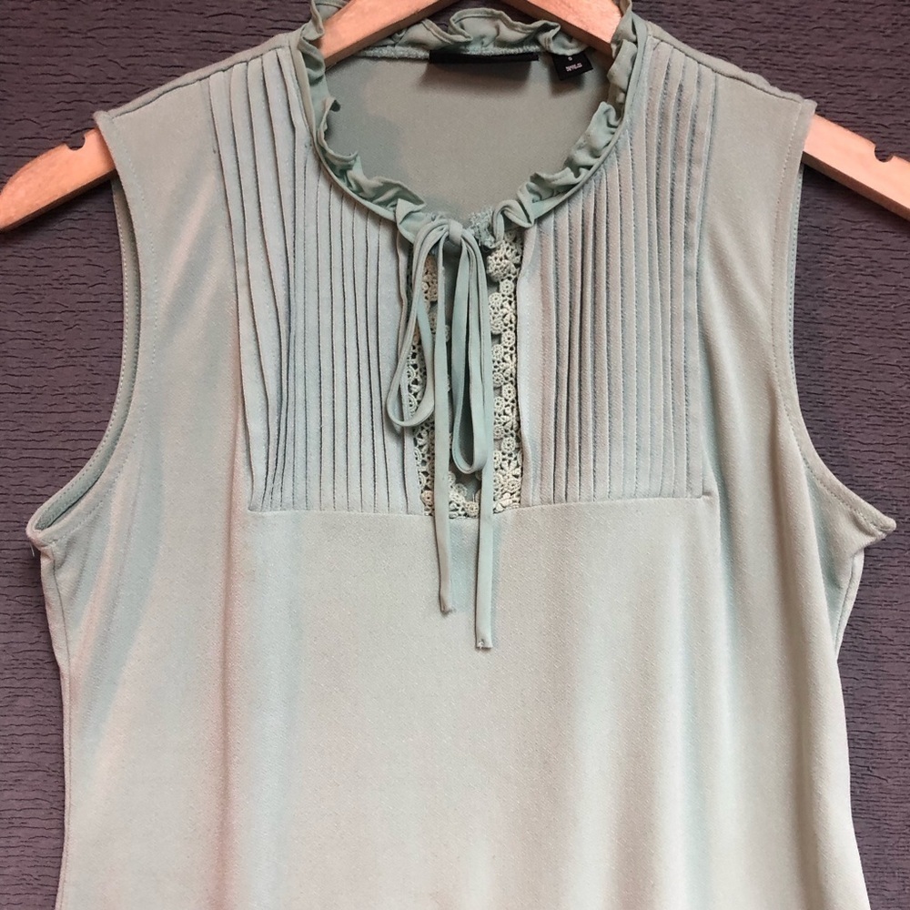 Seventh Avenue design studio, small light green top with pleats around the neck